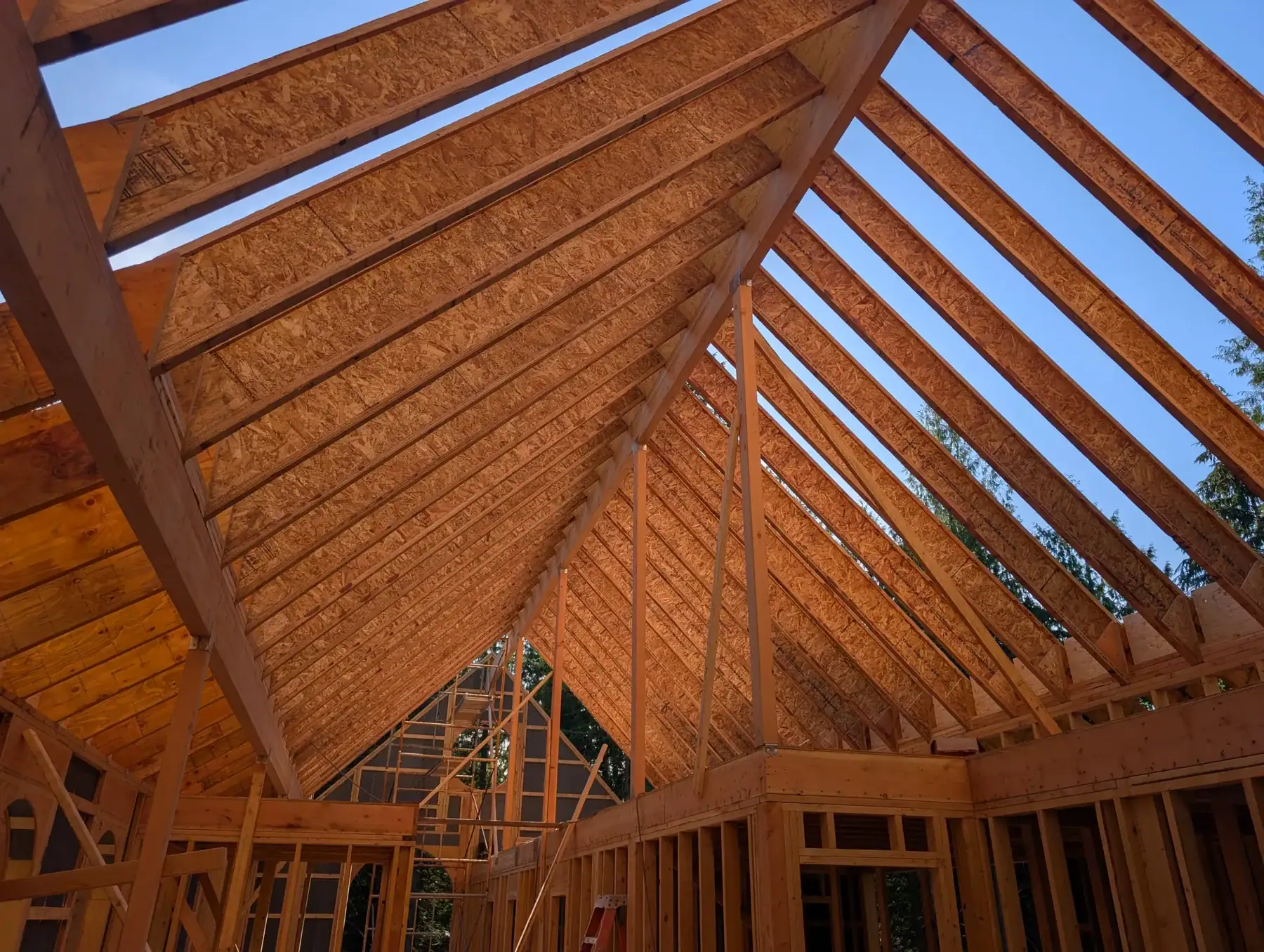 Detailed timber roof framing inside a Washington State custom home package.