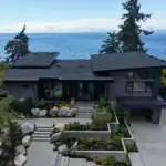 Aerial site view of a modern Sunshine Coast waterfront custom home integrated into coastal landscaping.