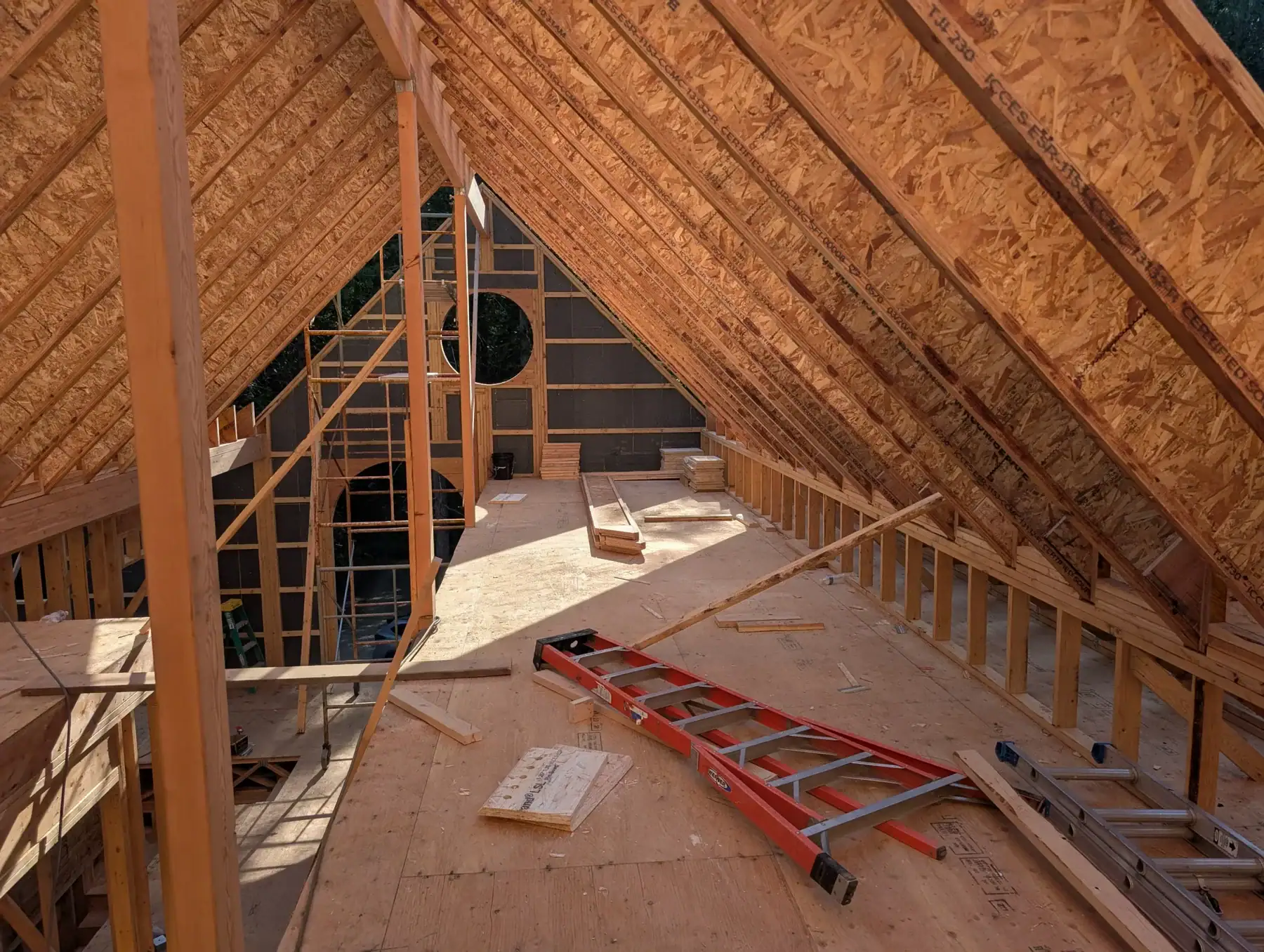 Interior vaulted roof framing taking shape inside a Washington State custom home package.