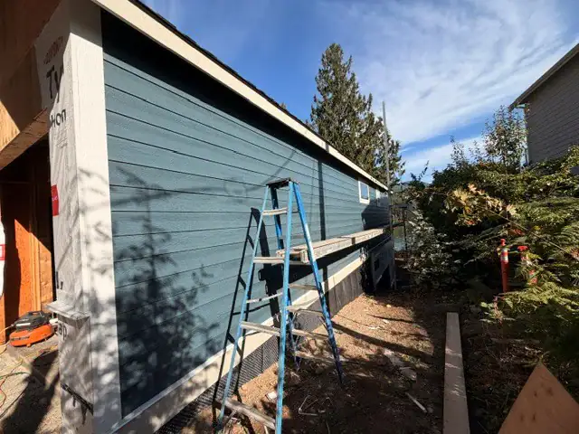 Stone Blue Hardie board lap siding being installed on a custom home in Washington State
