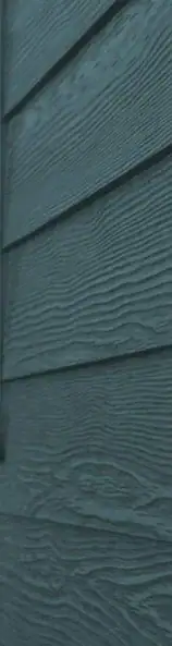 Close-up of Stone Blue Hardie board lap siding showing textured woodgrain finish
